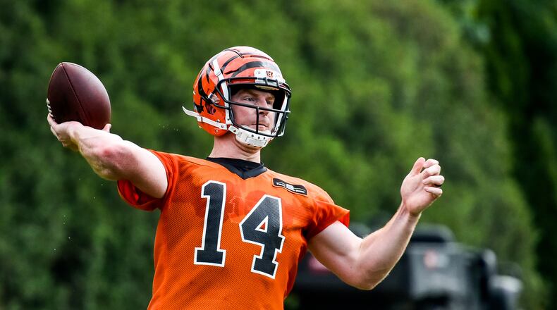 Bengals’ quarterback Andy Dalton makes a pass during organized team activities Tuesday, May 22 at the practice facility near Paul Brown Stadium in Cincinnati. NICK GRAHAM/STAFF