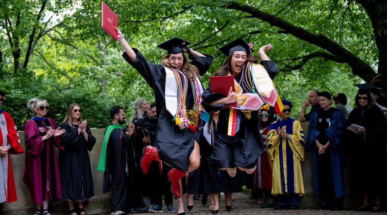Wittenberg University graduates do the traditional "stomp the seal" leap after Saturday's commencement ceremony at the college in Springfield. Photo courtesy John Coffman Photography