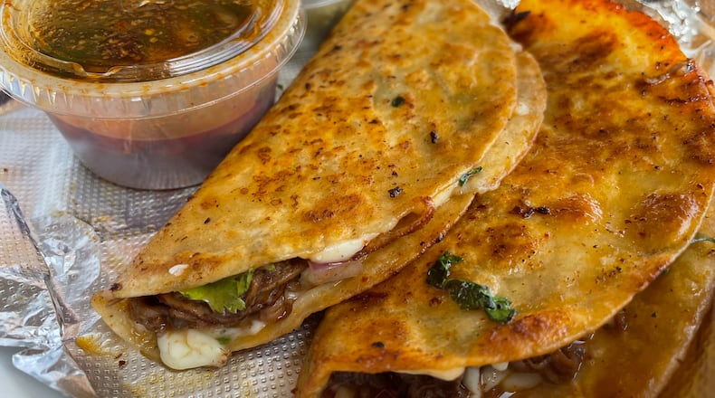 More Than A Apron in Miamisburg features Birria tacos made with beef, chicken or lamb, as well as Birria bowls, fries and mac and cheese. NATALIE JONES/STAFF