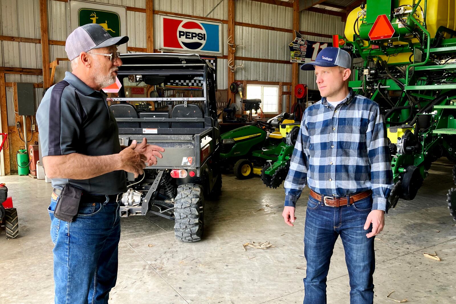 Farmer Rick Clifton, left, talks with Bryan Randall, an agronomist with Indigo Agriculture in Orient, Ohio, on April 5, 2021. (AP Photo/John Flesher)