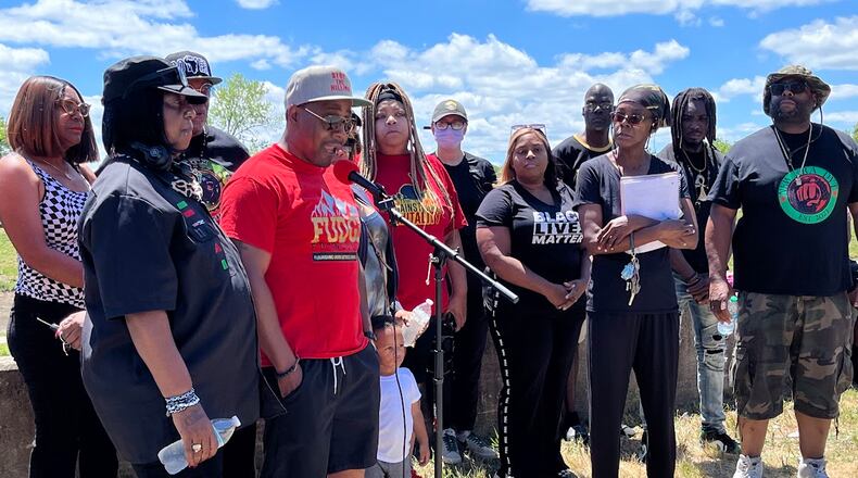 Dion Green, a community activist, speaks Sunday afternoon to a group grieving after the shooting of a youth Saturday by Dayton police. A rally was held on Negley Place, close to where the shooting happened. Participants said the person shot was 15 years old. THOMAS GNAU/STAFF