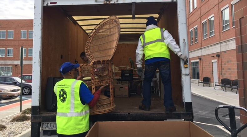David Battles, left, and Dennis Glover, both Goodwill workers, help unload a chair delivered to the donation center at the 660 S. Main St. Goodwill Easter Seals Miami Valley headquarters Dec. 7. THOMAS GNAU/STAFF