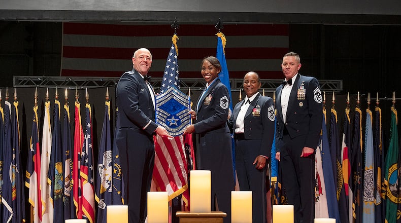 Col. Patrick Miller, 88th Air Base Wing and installation commander, presents a plaque to Chief Master Sgt. Starr Williams, U.S. Air Force School of Aerospace Medicine, during the Wright-Patterson Chief Master Sergeant Recognition Ceremony on May 14 at the National Museum of the U.S. Air Force. The event honored the Wright-Patt Airmen recently selected for promotion to the Air Force’s highest enlisted rank. U.S. AIR FORCE PHOTO/R.J. ORIEZ