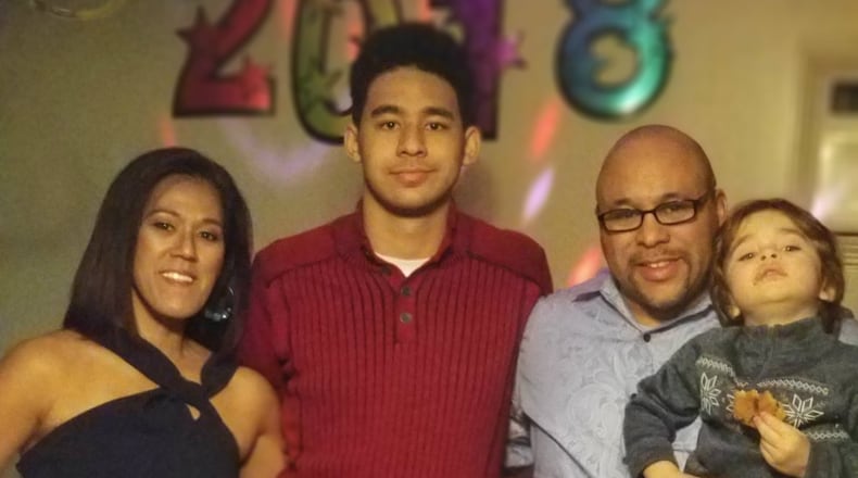Michael Newsom of Englewood holds his grandson, Maddox (right), and is pictured with his wife, Jane Newsom, and son, Julian Newsom, at the start of the new year. CONTRIBUTED
