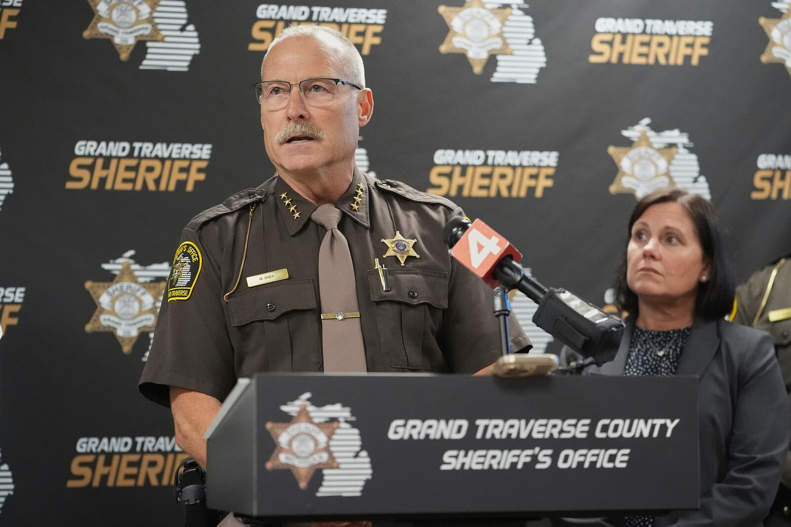Grand Traverse County Sheriff Mike Shea, left, speaks alongside Prosecutor Noelle Moeggenberg during a news conference Sunday, July 27, 2025, after 11 people were stabbed at a Walmart in Traverse City, Mich. (AP Photo/Ryan Sun)