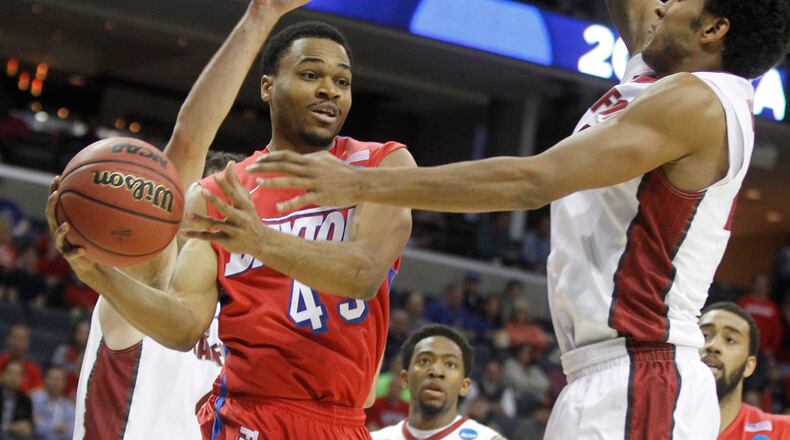 Dayton's Vee Sanford passes around Stanford's Josh Huestis in a Sweet 16 game on Thursday, March 27, 2014, at FedExForum in Memphis, Tenn. David Jablonski/Staff
