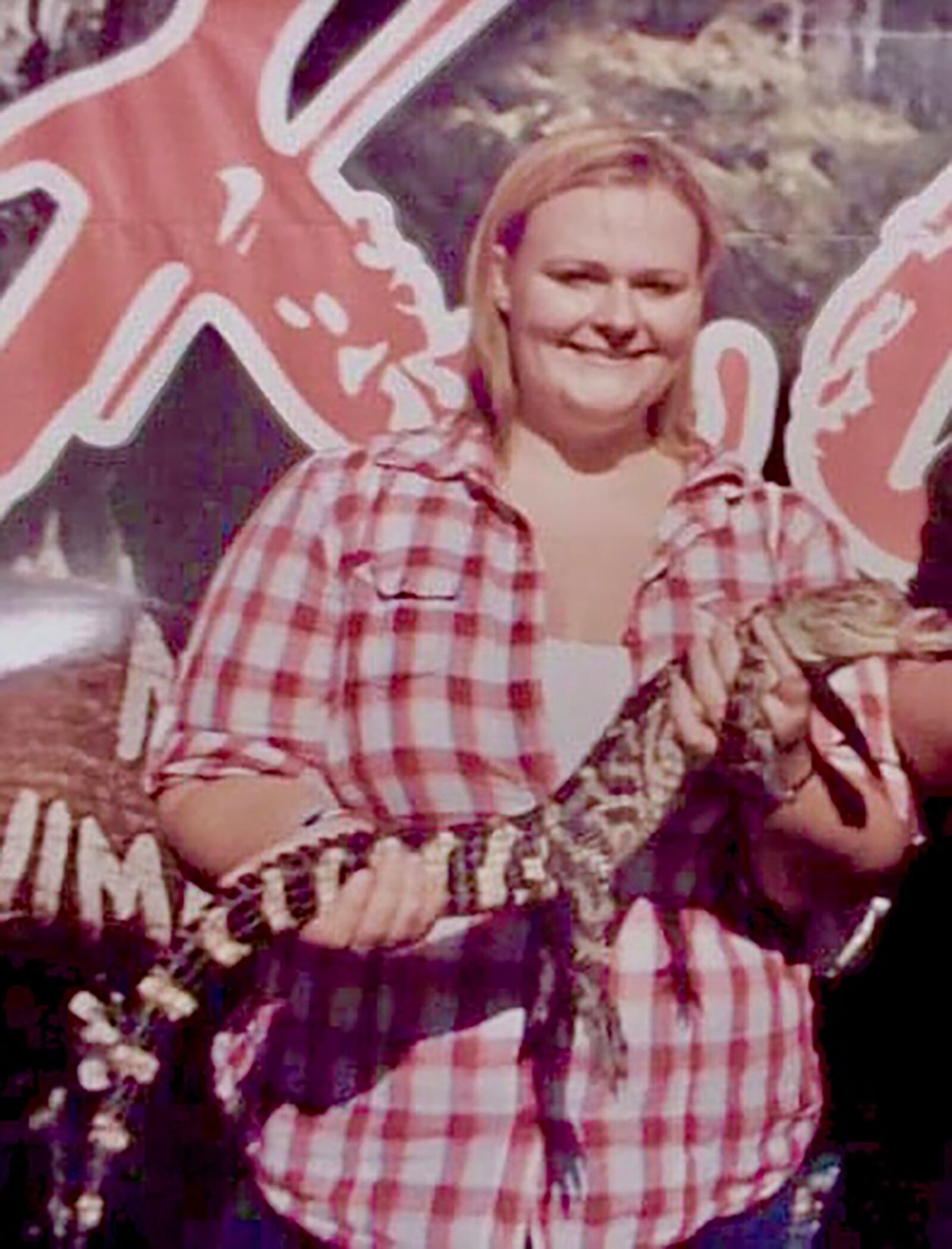 Heather Butler, in 2010 at the Montgomery County Fair, holds a baby alligator. Butler grew up around animals and gardening.