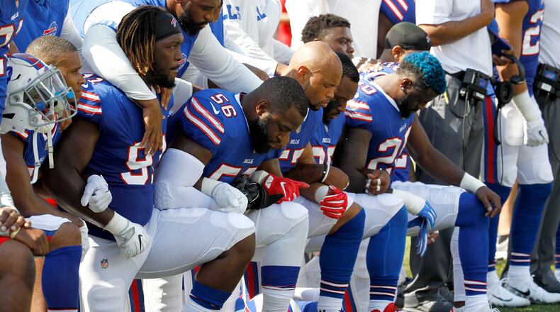 Buffalo Bills players kneel during the national anthem prior to an NFL football game against the Denver Broncos, Sunday, Sept. 24, 2017, in Orchard Park, N.Y. (AP Photo/Jeffrey T. Barnes)