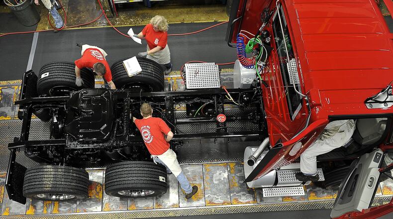 Navistar employees build a truck on the assembly line at Springfield plant in 2017. Bill Lackey/Staff