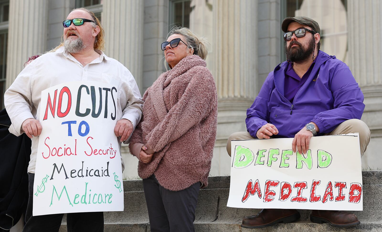 Members of SEIU 1199, a health care and social service union, demonstrate during a protest on Wednesday on West Third Street in downtown Dayton. The demonstrators were protesting in front of Rep. Mike Turner, R-Dayton, whose office is in the building that houses the United States Bankruptcy Court Southern District. BRYANT BILLING / STAFF