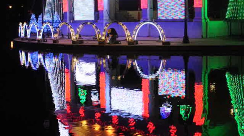 Xenia police chief, Randy Person, works on setting up the Xenia Lights, Monday night at Shawnee park. STAFF/MARSHALL GORBY