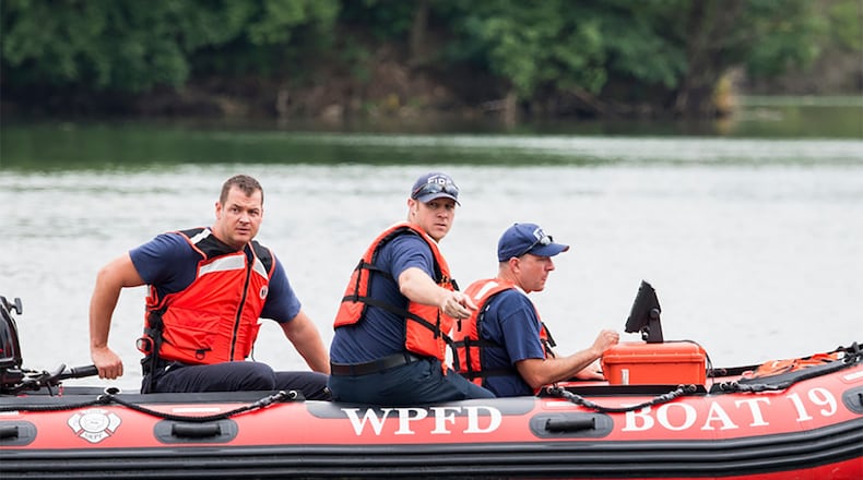 Dive-rescue team members from the Wright-Patterson Air Force Base Fire Department take part in a training event last August at Bass Lake. Pictured (from left) are firefighter Nathan Brown, Lt. Aron Chaney and firefighter/paramedic Keith Hawkins, with District Chief Timothy Howells in the water. CONTRIBUTED PHOTO