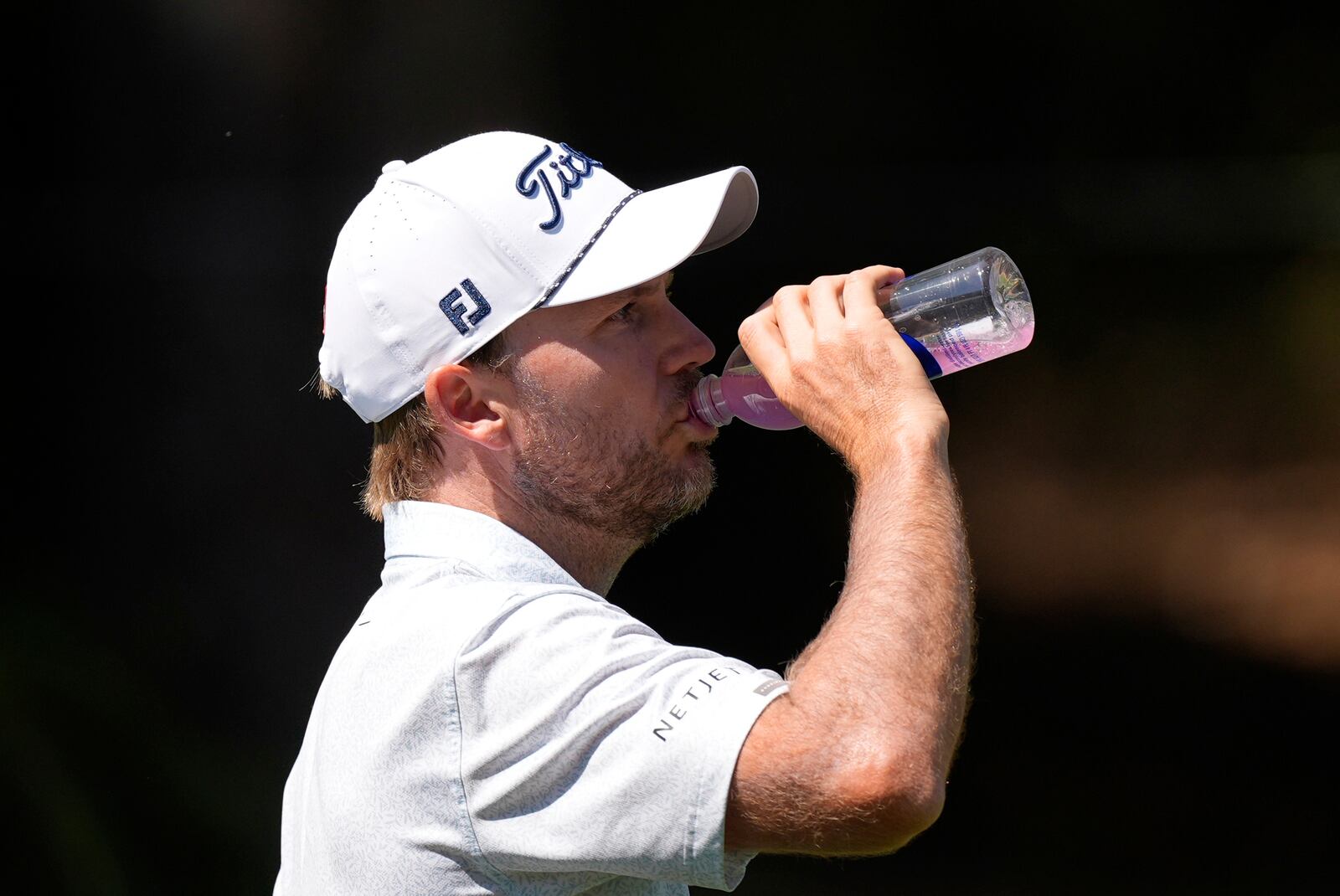 Russell Henley hydrates as he walks the eighth hole during the first round of the RBC Heritage golf tournament, Thursday, April 17, 2025, in Hilton Head Island, S.C. (AP Photo/Mike Stewart)