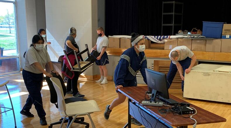 Students from the 88th Medical Group’s Medical Laboratory Apprentice Phase II Program move furniture at the Wright-Patterson USO Center Oct. 8 to help prepare the center for its phased reopening, starting Oct. 19. CONTRIBUTED PHOTO