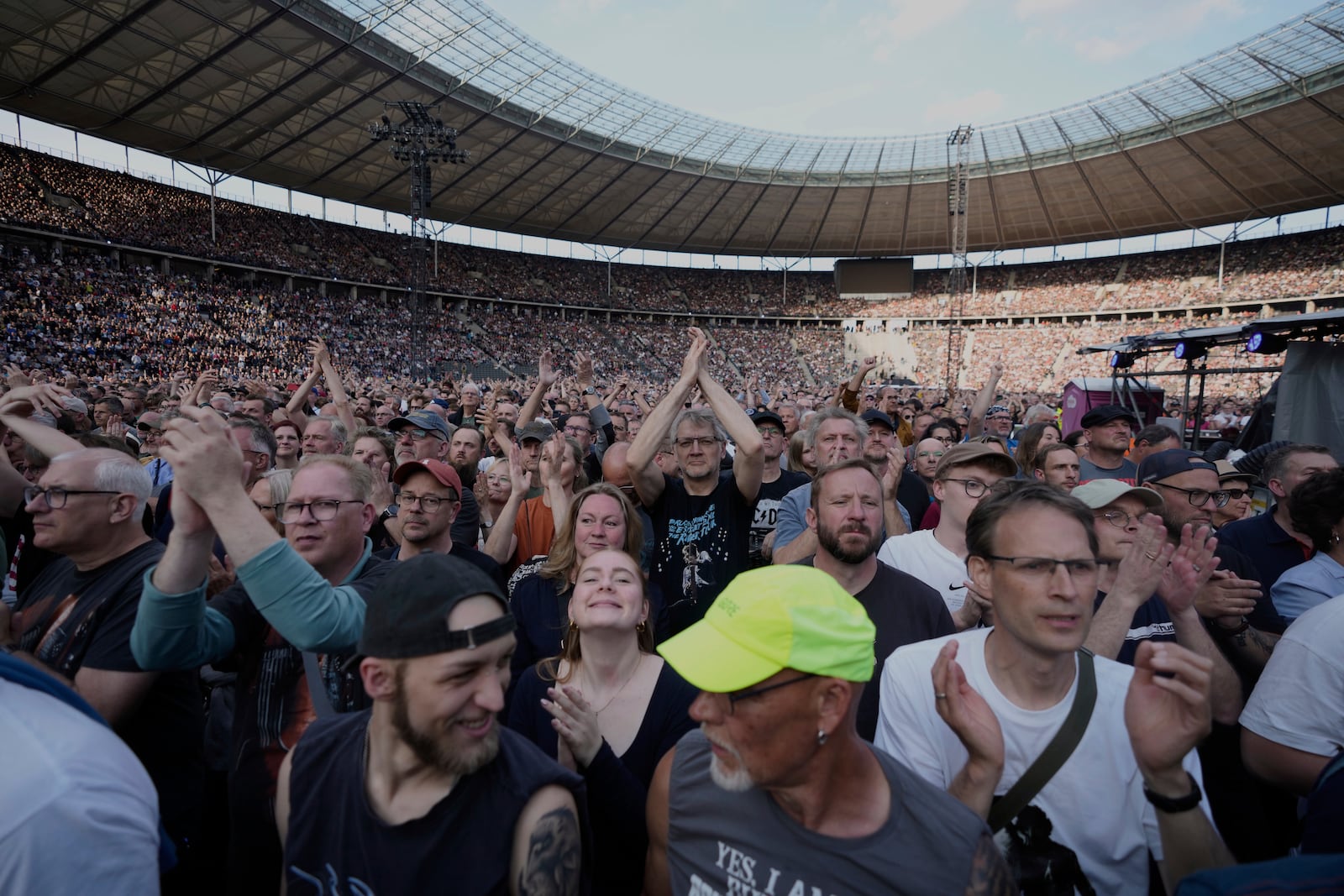 Spectators watch Bruce Springsteen and the E Street Band perform at the Olympic Stadium, in Berlin, Germany, Wednesday, June 11, 2025. (AP Photo/Markus Schreiber)
