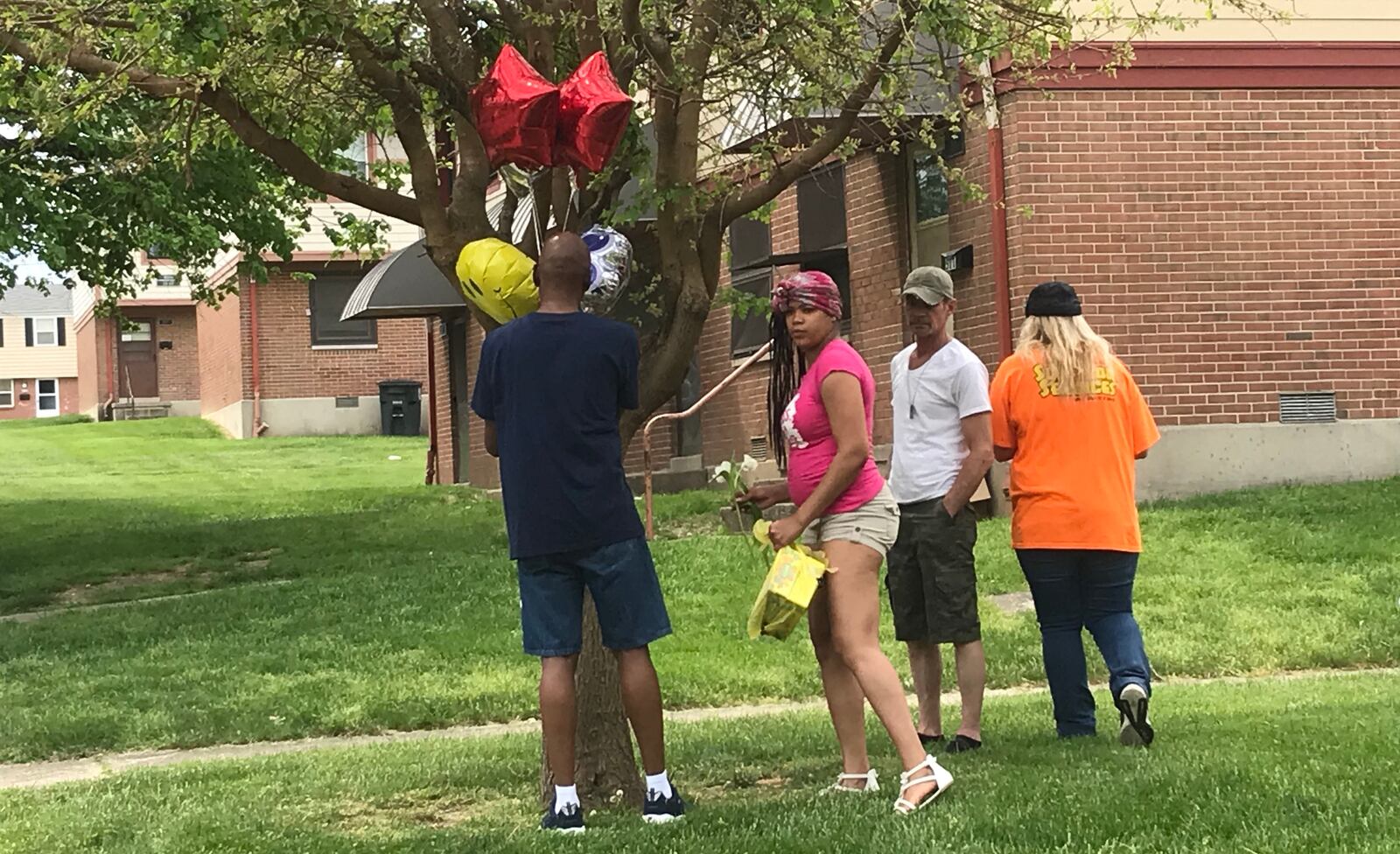 Family and friends place balloons May 12, 2018, at the site near where 6-year-old Genae L. Taste was struck and killed the day before in the 500 block of Ingram Street in Dayton.
