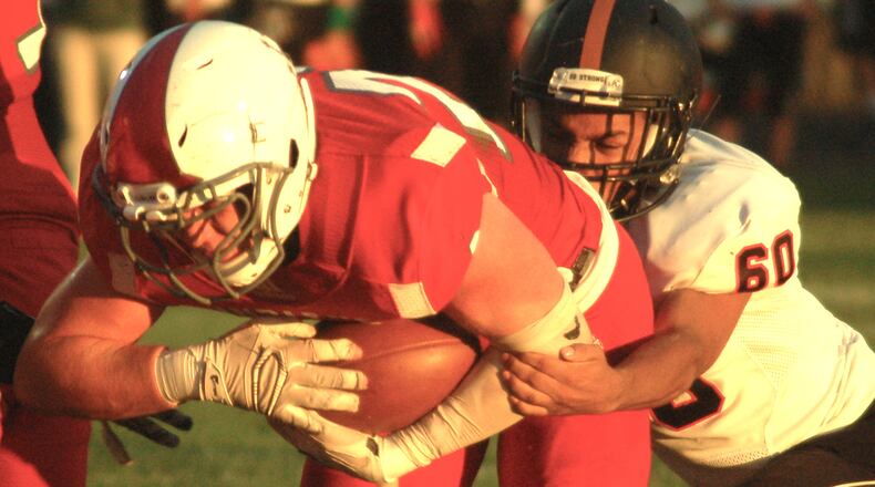 Carlisle’s Spencer Mays dives into the end zone as Waynesville’s Anthony Curry tries to make the tackle during Friday night’s game at Laughlin Field in Carlisle. CONTRIBUTED PHOTO BY JOHN CUMMINGS