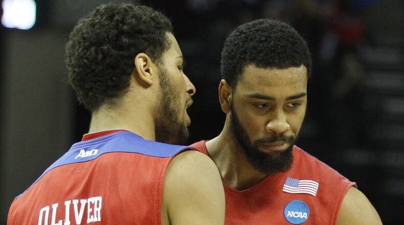 Dayton’s Devin Oliver, left, and Devon Scott celebrate after a basket against Stanford in the Sweet 16 on Thursday, March 27, 2014, at FedExForum in Memphis, Tenn. David Jablonski/Staff