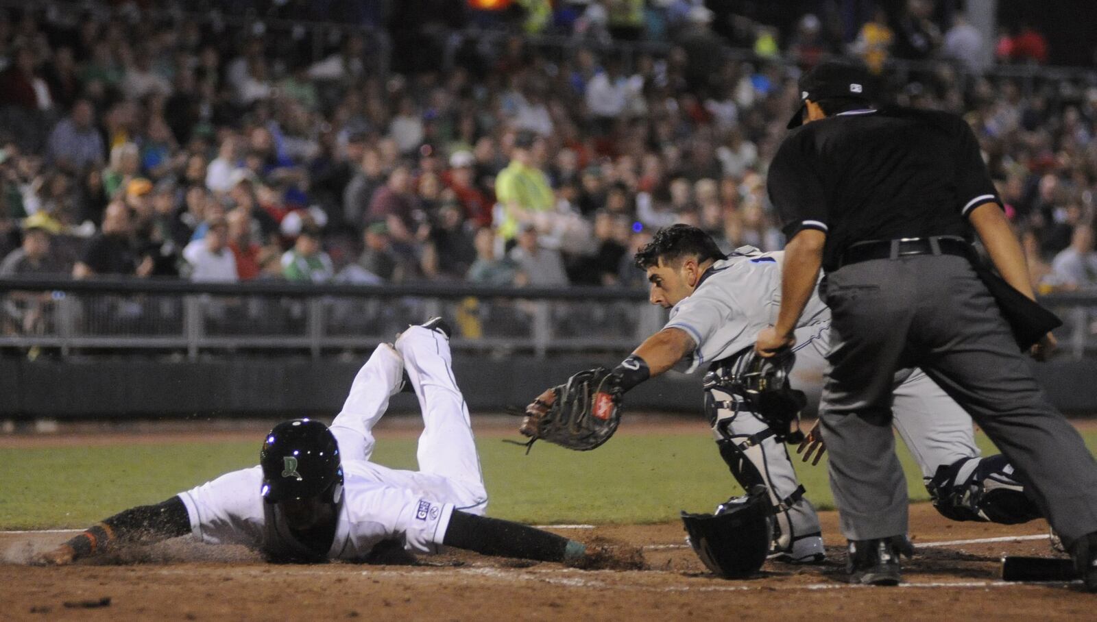 Jose Siri of the Dragons and Whitecaps catcher Tim Remes. The Dragons defeated the visiting West Michigan Whitecaps (Tigers) 2-0 in a Class A minor-league baseball game at Dayton’s Fifth Third Field on Monday, April 10, 2017. MARC PENDLETON / STAFF