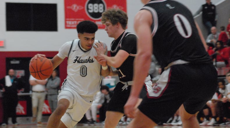 Lakota East's Trey Perry (0) is guarded by La Salle's Cohen Kreidler on Friday night. Chris Vogt/CONTRIBUTED