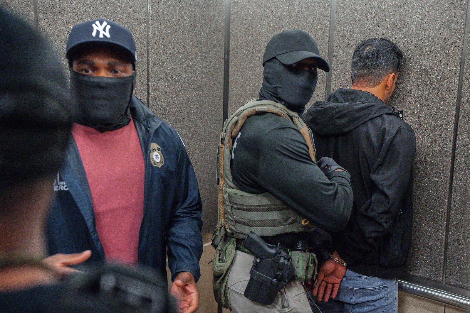 FILE - Immigration and Customs Enforcement agents escort a detained immigrant into an elevator after he exited an immigration courtroom, Tuesday, June 17, 2025, in New York. (AP Photo/Olga Fedorova, file)