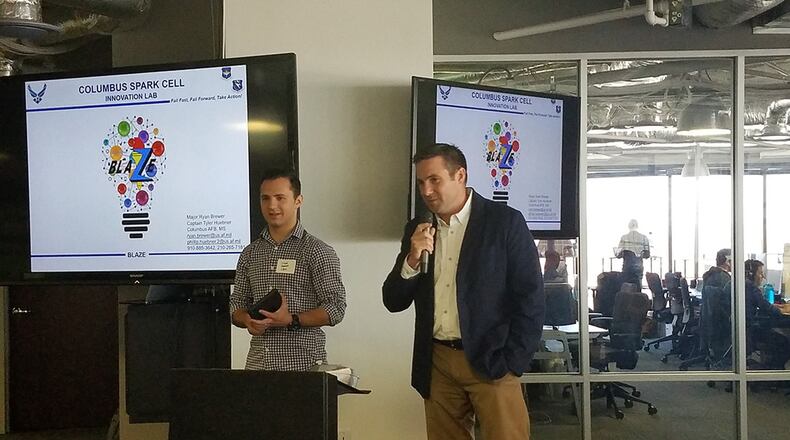 Maj. Ryan Brewer (right), 14th Flying Training Wing Spark Cell director, explains how the Columbus Air Force Base, Miss., Spark Cell is creating a culture of innovation at the AFWERX Spark Cell Workshop Dec. 13 in Austin, Texas. The workshop was designed to help grow the network of willing collaborators and share ideas and approaches that foster a results-driven culture of innovation. (Courtesy photo)