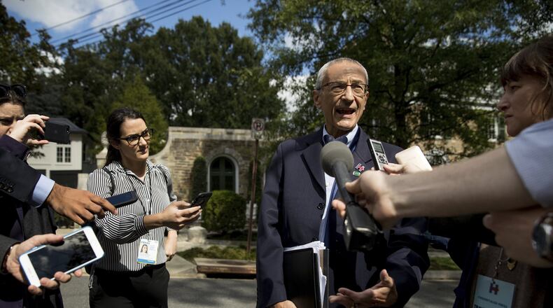 In this photo taken Oct. 5, 2016, Hillary Clinton’s campaign manager John Podesta speaks to members of the media outside Democratic presidential candidate Hillary Clinton’s home in Washington. (AP Photo/Andrew Harnik)