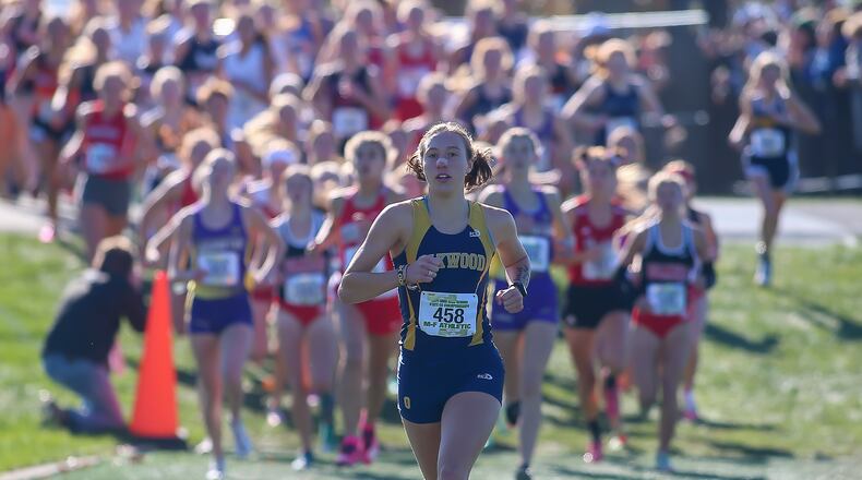 Cutline: Oakwood High School senior Grace Hartman leads the pack during the Division II girls race at the Ohio High School Athletic Association Cross Country Championships at Fortress Obetz. Hartman won the state championship for the second straight year. Michael Cooper/CONTRIBUTED