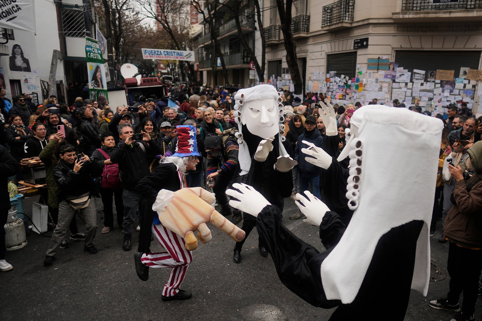 Supporters of Argentina's former President Cristina Fernandez gather outside her home one week after the nation's Supreme Court upheld her corruption conviction in Buenos Aires, Argentina, Tuesday, June 17, 2025. (AP Photo/Natacha Pisarenko)