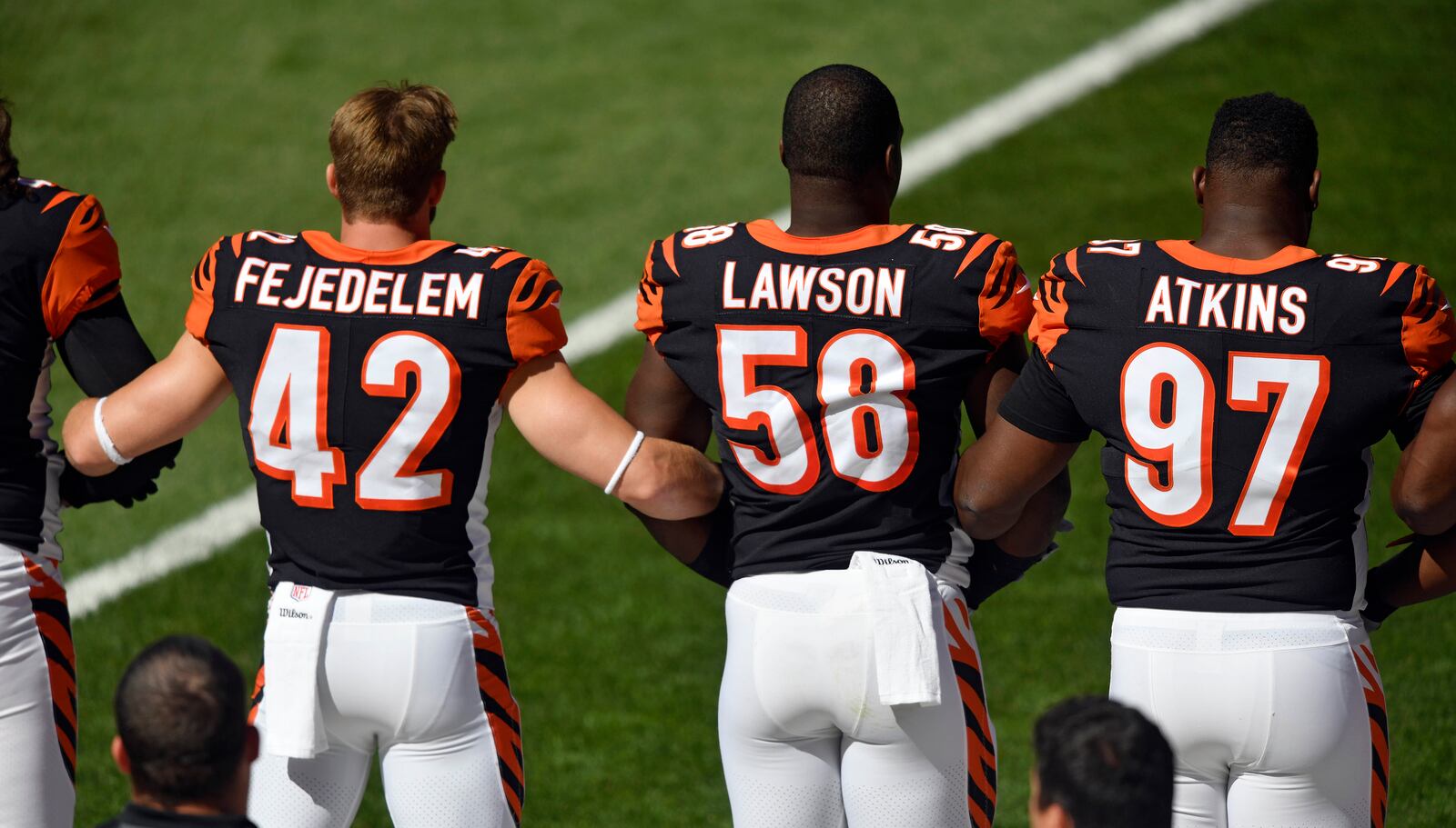 Members of the Cincinnati Bengals lock arms during the national anthem before an NFL football game against the Cleveland Browns, Sunday, Oct. 1, 2017, in Cleveland. (AP Photo/David Richard)