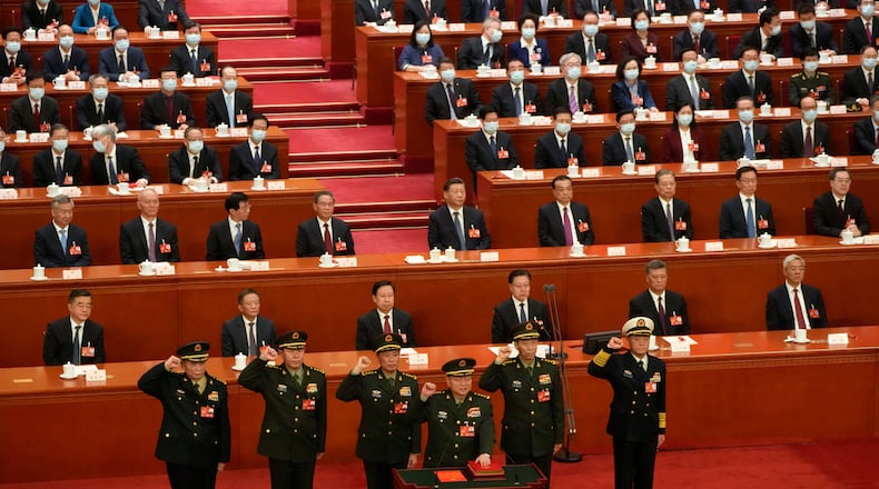 FILE - Chinese President Xi Jinping, center, watches as members of the Central Military Commission takes their oath during a session of China's National People's Congress (NPC) at the Great Hall of the People in Beijing, China on March 11, 2023. (AP Photo/Mark Schiefelbein, File)