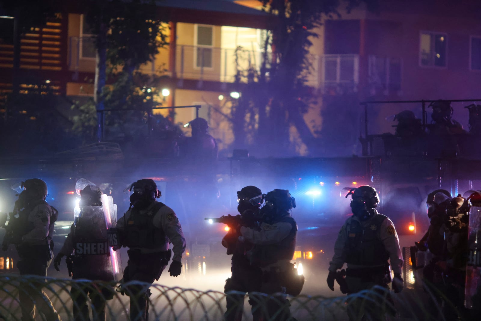 Law enforcement stand during a protest in Compton, Calif., Saturday, June 7, 2025, after federal immigration authorities conducted operations. (AP Photo/Ethan Swope)