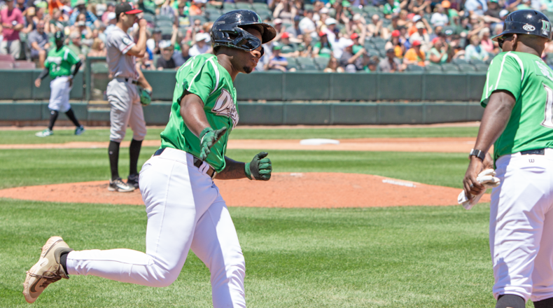 Cam Collier is greeted by first-base coach Jefry Sierra after hitting a home run in a game earlier this season. Collier cracked three home runs in Friday's win. Jeff Gilbert/CONTRIBUTED