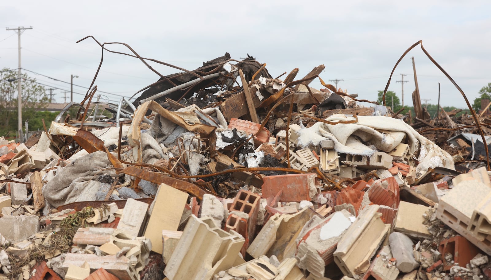 Debris from the demolition of McCook Bowl on Keowee Street in Dayton is pictured on Thursday, May 8, 2025. David Jablonski/Staff