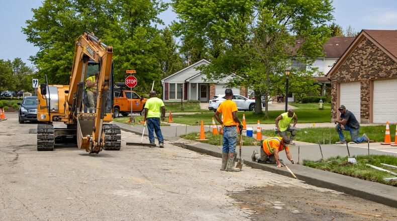 Paving crews repair streets and curbs in Beavercreek. FILE