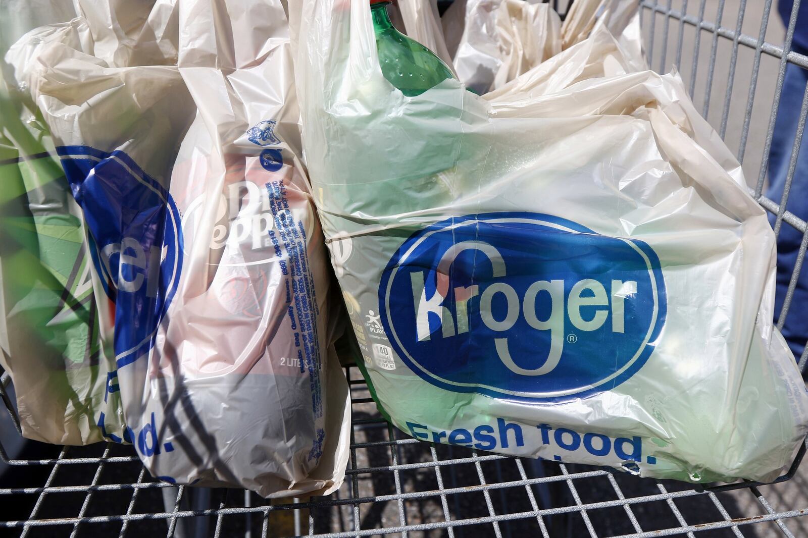 In this June 15, 2017, photo, bagged purchases from the Kroger grocery store in Flowood, Miss., sit inside this shopping cart. Kroger reports financial results on Wednesday, March 7, 2018. (AP Photo/Rogelio V. Solis)
