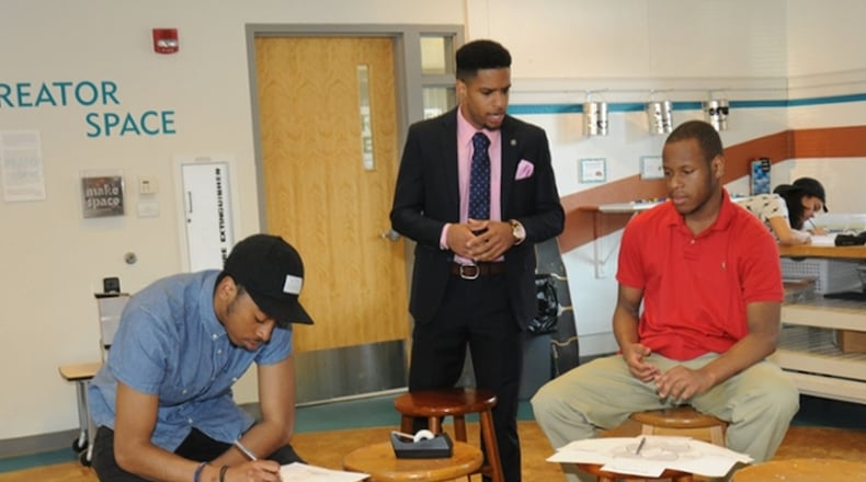 The University of Dayton has hired Karlos L. Marshall, center, as manager of the Greater West Dayton Incubator. CONTRIBUTED