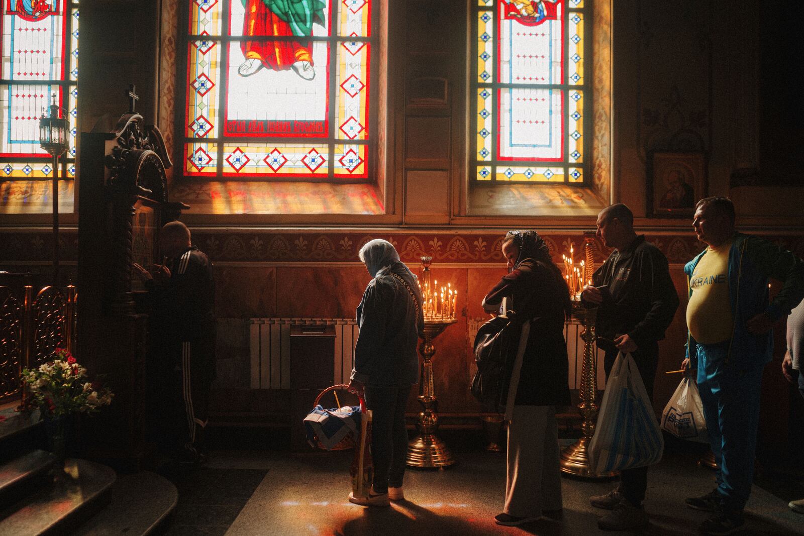 People stand in line to kiss an icon during the celebration of Orthodox Easter at Cross Lower Church of the Ukrainian Orthodox Church in Kharkiv, Ukraine, on Sunday, April 20, 2025. (AP Photo/George Ivanchenko)