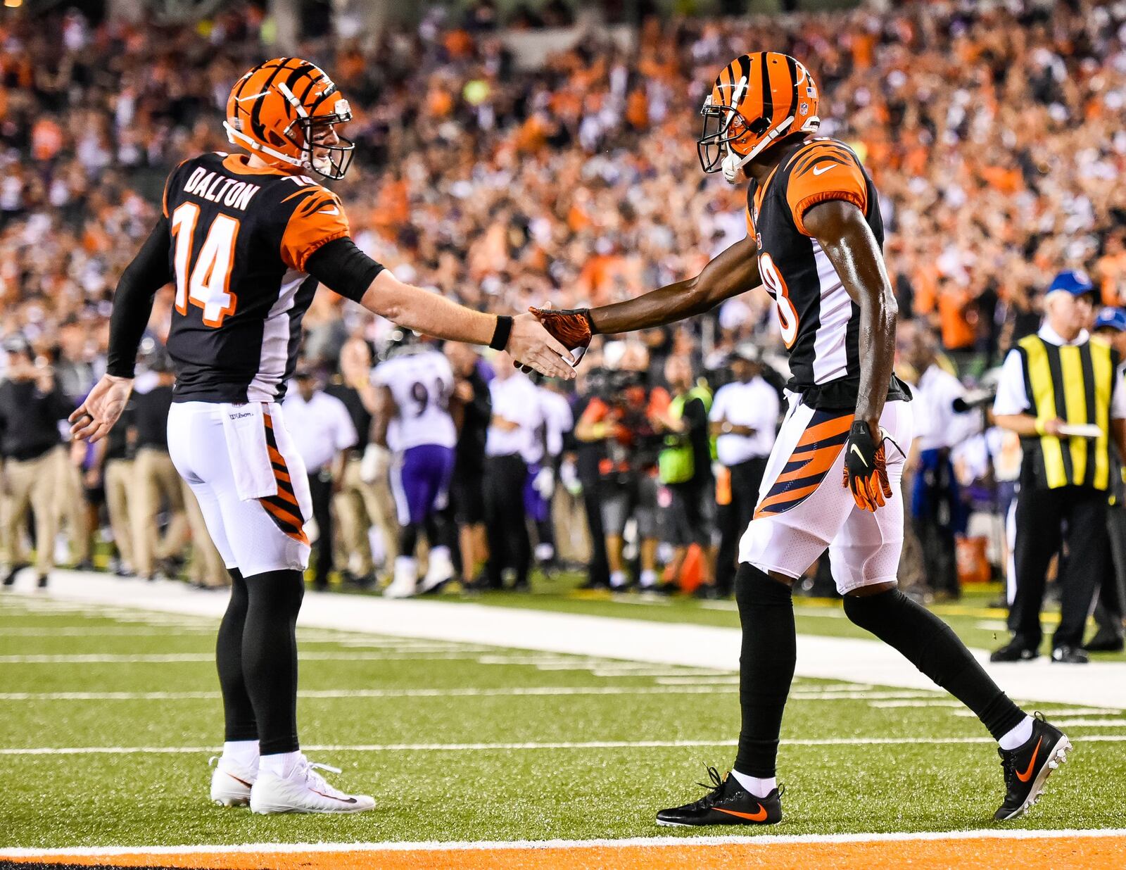 Cincinnati Bengals quarterback Andy Dalton, left, gives five to wide receiver A.J. Green after Green score a touchdown Thursday, Sept. 13 at Paul Brown Stadium in Cincinnati. The Cincinnati Bengals defeated the Baltimore Ravens 34-23. NICK GRAHAM/STAFF