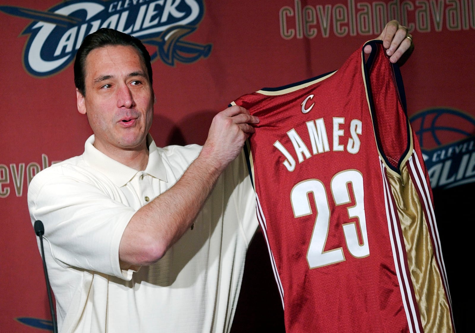FILE - Cleveland Cavaliers General Manager Jim Paxson holds up the No. 23 jersey with LeBron James' name on the back during an NBA basketball news conference at Gund Arena in Cleveland Friday, May 23, 2003.. (AP Photo/Mark Duncan, File)