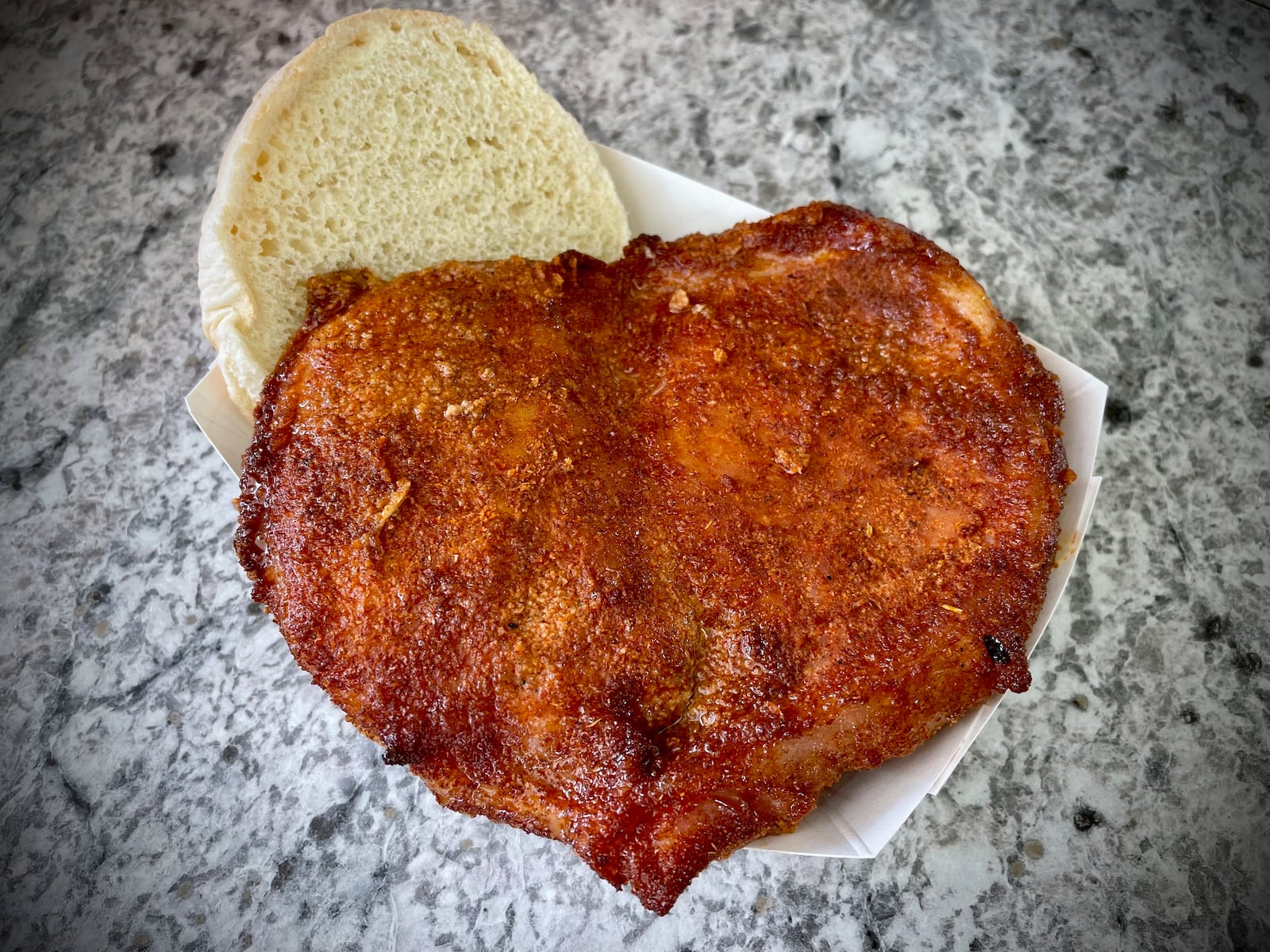 Grumpy’s BBQ is known for the butterfly pork chop.  NATALIE JONES/STAFF