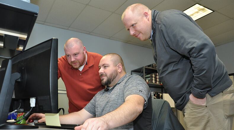 The Windows 10 migration was a topic for discussion for James Languirand, Information Technology specialist, Dave Hall, Automated Data Processing Equipment custodian, and John Schipper, Helpdesk technician, as they worked together to ensure that Wright-Patterson Air Force Base’s Air Force Security Assistance Center, meets the Air Force’s March 31 deadline for the transition to the new operating system. (U.S. Air Force photo/Will Huntington)