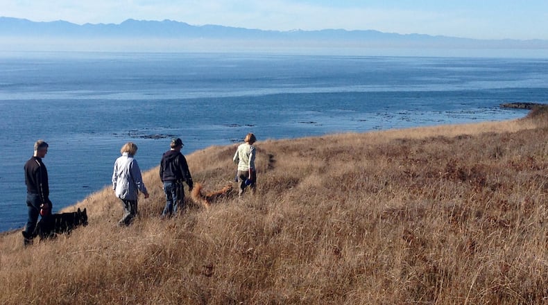 Hikers on the bluff at Iceberg Point, looking out from the southern tip of Lopez Island to the Strait of Juan de Fuca and the Olympic Range. (Brian J. Cantwell /Seattle Times/TNS)