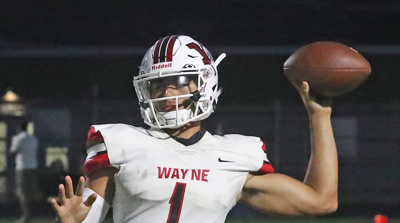 Wayne quarterback Cam Fancher throws a pass against Springfield. BILL LACKEY/STAFF