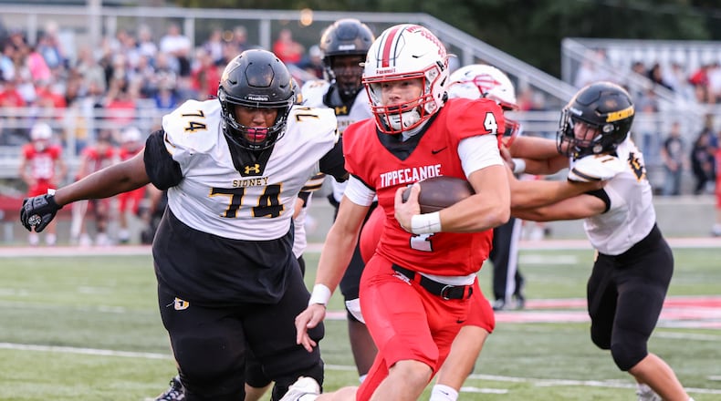 Tippecanoe junior quarterback Larkin Thomas runs during a Miami Valley League game against Sidney on Thursday, Sept. 25 at Tipp City Park. BRYANT BILLING / STAFF