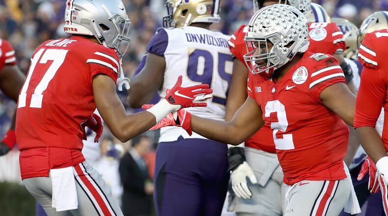 PASADENA, CA - JANUARY 01: Chris Olave #17 of the Ohio State Buckeyes and J.K. Dobbins #2 of the Ohio State Buckeyes celebrate after a touchdown during the second half in the Rose Bowl Game presented by Northwestern Mutual at the Rose Bowl on January 1, 2019 in Pasadena, California.  (Photo by Sean M. Haffey/Getty Images)