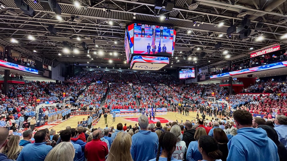 Dayton and Marquette stand for the national anthem on Saturday, Dec. 14, 2024, at UD Arena. David Jablonski/Staff