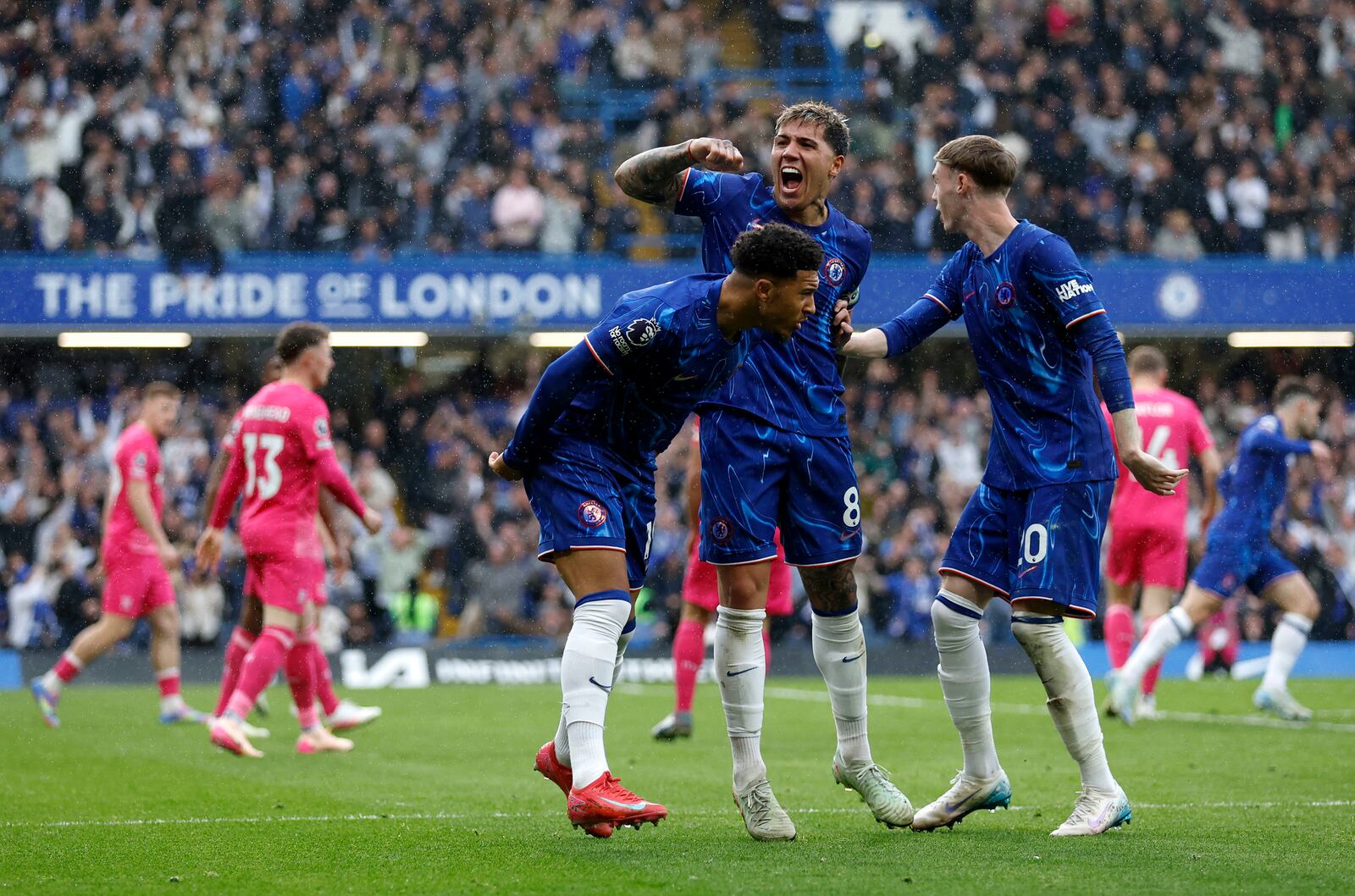 Chelsea's Jadon Sancho, left, celebrates with Enzo Fernandez, centre, and Cole Palmer after scoring their side's second goal of the game during the English Premier League soccer match between Chelsea and Ipswich Town at Stamford Bridge in London, Sunday April 13, 2025. (Nigel French/PA via AP)