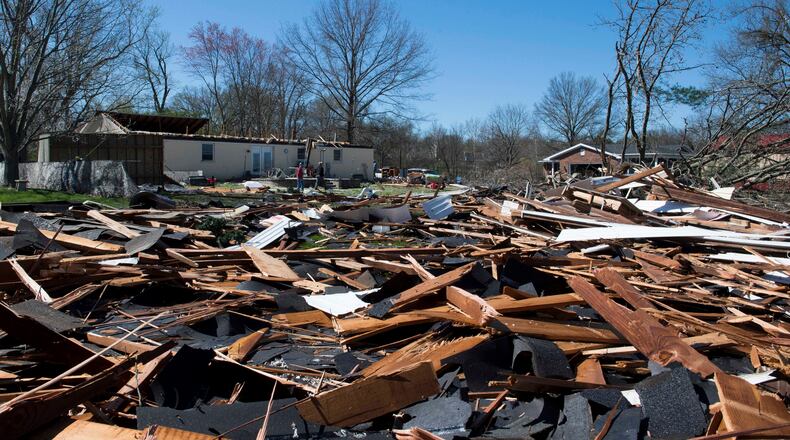 Roof debris from a home off Sharon Road is thrown into the surrounding yards after being ripped off due to damaging winds Saturday night in Newburgh, Ind., Sunday morning, March 29, 2020. A tornado crossed the Ohio River from Kentucky and hit the Newburgh area, Saturday night, tearing roofs off homes and toppling trees and power lines.  (MaCabe Brown /Evansville Courier & Press via AP)