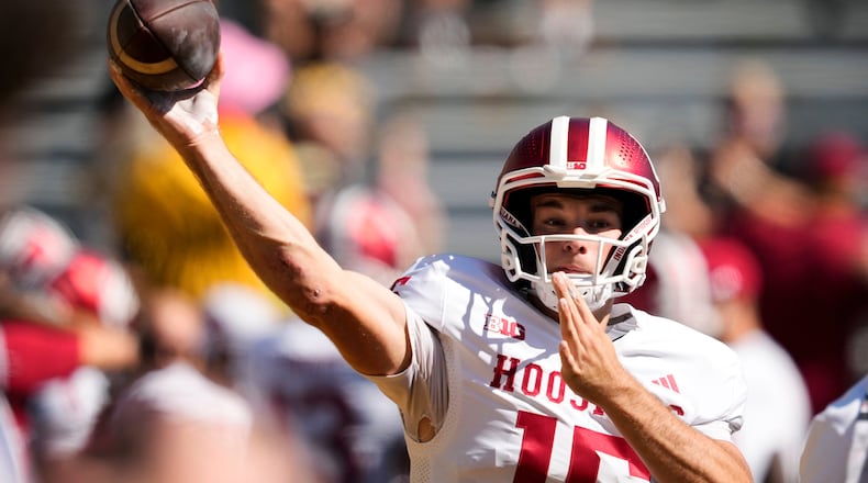 FILE - Indiana quarterback Fernando Mendoza warms up before an NCAA college football game against Iowa, Saturday, Sept. 27, 2025, in Iowa City, Iowa. (AP Photo/Charlie Neibergall, File)